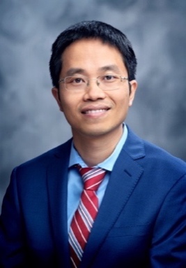 A person in a suit and tie
Description automatically generated